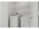 Functional laundry room featuring a washer and dryer with overhead shelving at 2633 Chin Cactus Ct, Las Vegas, NV 89106