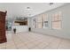 Bright living room with tile flooring, open to the kitchen, and offering a seamless flow to the outdoor patio at 2633 Chin Cactus Ct, Las Vegas, NV 89106