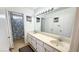 Bright bathroom with double sinks, framed mirror, and a shower and toilet adjacent at 2722 Sweet Basil Dr, Las Vegas, NV 89142
