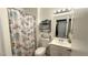 Cozy bathroom featuring a shower-tub combination, vanity, decorative mirror, and seashell decor at 2722 Sweet Basil Dr, Las Vegas, NV 89142