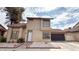 Charming two-story home with stucco siding, tile roof, attached garage, and manicured front yard at 2722 Sweet Basil Dr, Las Vegas, NV 89142