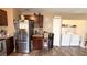 This kitchen features wood cabinets, stainless steel refrigerator, and a convenient washer and dryer at 2722 Sweet Basil Dr, Las Vegas, NV 89142