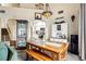 Open dining area with a wooden table and bench seating, flowing into the kitchen and living room at 2809 Du Barry Manor Ln, Las Vegas, NV 89108