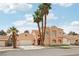 Charming two-story home with desert landscaping, palm trees and a spacious front yard under a blue sky at 2809 Du Barry Manor Ln, Las Vegas, NV 89108