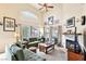 Spacious living room with large windows, fireplace, plush seating, and natural light at 2809 Du Barry Manor Ln, Las Vegas, NV 89108