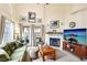 Comfortable living room with fireplace, large windows, and stylish decor, creating a warm atmosphere at 2809 Du Barry Manor Ln, Las Vegas, NV 89108