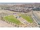 An aerial view of the community with desert landscape and a green park at 3240 Avernus Ave, Henderson, NV 89044
