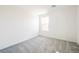 Bright bedroom featuring gray carpet, a single window, and fresh white paint at 3240 Avernus Ave, Henderson, NV 89044