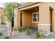Cozy covered front porch with attractive stone supports and landscaping at 3240 Avernus Ave, Henderson, NV 89044