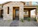 Inviting front porch with stone accents and manicured landscaping at 3240 Avernus Ave, Henderson, NV 89044