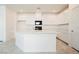 A modern kitchen with white cabinets, a large island with a quartz countertop, and stainless-steel appliances at 3240 Avernus Ave, Henderson, NV 89044