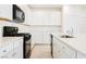 Modern kitchen with white cabinets, a large island with quartz countertop, and stainless-steel appliances at 3240 Avernus Ave, Henderson, NV 89044