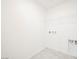 Clean laundry room with a wire shelf and hookups for washer and dryer at 3240 Avernus Ave, Henderson, NV 89044