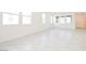 Spacious living area featuring tiled flooring and abundant natural light from large windows at 3240 Avernus Ave, Henderson, NV 89044
