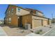 Exterior of townhome showing garages, AC unit, and desert landscaping at 3240 Avernus Ave, Henderson, NV 89044