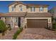 Charming two-story home featuring a stone-accented facade and a spacious two-car garage at 3426 Oristano Ln, Henderson, NV 89044