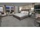 Luxurious primary bedroom features a decorative headboard, large windows, and stylish accent furniture at 3426 Oristano Ln, Henderson, NV 89044