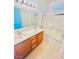 Bright bathroom with dual sinks, tile flooring, and a shower-tub combination with glass doors at 3936 Pepper Thorn Ave # 102, North Las Vegas, NV 89081