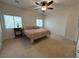 Bedroom with a ceiling fan, two windows, and a comfortable bed and side table at 3936 Pepper Thorn Ave # 102, North Las Vegas, NV 89081