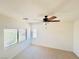 Bright bedroom featuring a ceiling fan, dual windows, and light colored carpet at 3936 Pepper Thorn Ave # 102, North Las Vegas, NV 89081