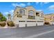 Two-story condo with a three-car garage, desert landscaping, and unit number visible at 3936 Pepper Thorn Ave # 102, North Las Vegas, NV 89081