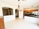 Open-concept kitchen with tile floors, breakfast bar, oak cabinets, and modern appliances at 3936 Pepper Thorn Ave # 102, North Las Vegas, NV 89081