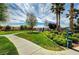A community park has green grass, mature trees, sidewalk and a waste station for dog owners at 3936 Pepper Thorn Ave # 102, North Las Vegas, NV 89081