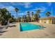 Community pool area with palm trees, clear blue water, sun deck, and pool house at 3936 Pepper Thorn Ave # 102, North Las Vegas, NV 89081