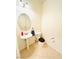 Compact powder room featuring a pedestal sink, tile floors, and a round mirror at 3936 Pepper Thorn Ave # 102, North Las Vegas, NV 89081