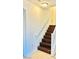 A staircase with dark wood steps and white railing leads to the upper floor at 3936 Pepper Thorn Ave # 102, North Las Vegas, NV 89081