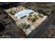 Aerial view of a sprawling ranch home with a large lot, mature trees, and a circular driveway at 3950 Oakridge Ave, Pahrump, NV 89048