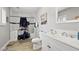 Bathroom featuring a white marble-look tiled shower, white vanity with stainless steel hardware, and wood look flooring at 3950 Oakridge Ave, Pahrump, NV 89048