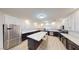 Spacious kitchen featuring an island, stainless steel appliances, granite countertops, and white cabinets at 3950 Oakridge Ave, Pahrump, NV 89048