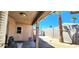 Backyard showcasing a covered patio, concrete walkway, stucco wall and white storage shed in the desert landscaping at 4119 Meadowglen Cir, Las Vegas, NV 89121