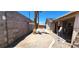 Enclosed backyard featuring desert landscaping, stucco walls, and covered patio with access to the house at 4119 Meadowglen Cir, Las Vegas, NV 89121