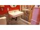 Bathroom featuring a sink, toilet, bathtub with shower, red wall and tiled flooring at 4119 Meadowglen Cir, Las Vegas, NV 89121