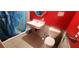 Bathroom features a toilet, sink, shower with red wall and tiled flooring at 4119 Meadowglen Cir, Las Vegas, NV 89121