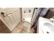 Bathroom featuring a walk-in shower, beige tile flooring, and white fixtures at 4119 Meadowglen Cir, Las Vegas, NV 89121