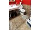 Bathroom features a toilet, sink, tiled flooring, and a white bathtub at 4119 Meadowglen Cir, Las Vegas, NV 89121