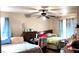 Cozy bedroom with ceiling fan, two beds, and natural light from windows at 4119 Meadowglen Cir, Las Vegas, NV 89121