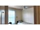 Neutral bedroom offers a comfortable bed and ceiling fan at 4119 Meadowglen Cir, Las Vegas, NV 89121