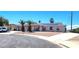 Single-story home with solar panels, front yard desert landscaping, palm trees, and a curved driveway at 4119 Meadowglen Cir, Las Vegas, NV 89121