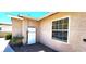Exterior view of Tesla power wall on stucco home by window with gravel ground cover at 4119 Meadowglen Cir, Las Vegas, NV 89121