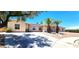 Inviting single-story home with xeriscaping, mature trees, and a wide driveway leading to a double-door entrance at 4119 Meadowglen Cir, Las Vegas, NV 89121