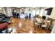 A spacious, well-lit living area features wood floors, an open kitchen, and a large dining table at 4119 Meadowglen Cir, Las Vegas, NV 89121