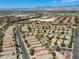 A scenic aerial view of a desert neighborhood, showcasing the community's layout and mountain views at 4124 Gliding Gulls Ave, North Las Vegas, NV 89084