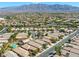 Expansive aerial view of the community, showcasing the neighborhood's layout against a backdrop of mountains at 4124 Gliding Gulls Ave, North Las Vegas, NV 89084