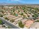 Aerial view of a community showcasing homes, desert landscaping, and mountain views in the distance at 4124 Gliding Gulls Ave, North Las Vegas, NV 89084