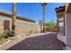 Desert backyard featuring gravel, block wall, and a variety of desert trees and shrubs at 4124 Gliding Gulls Ave, North Las Vegas, NV 89084