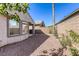 Landscaped backyard featuring a mix of rock and greenery, offering a private and serene outdoor retreat at 4124 Gliding Gulls Ave, North Las Vegas, NV 89084